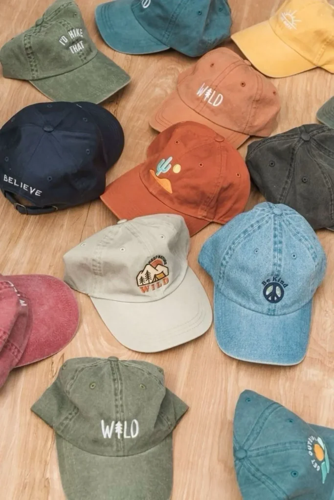 Verschiedene Dad Hats in unterschiedlichen Farben auf einer Holzoberfläche angeordnet