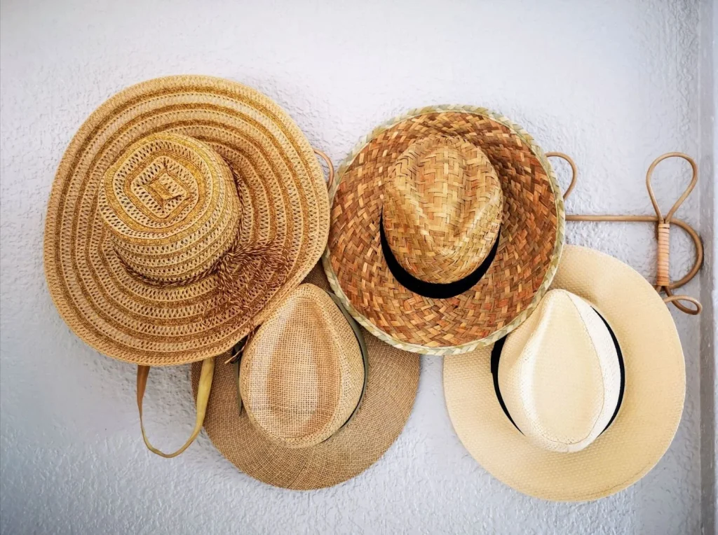 Various straw hats in different styles and textures arranged on a white background Various straw hats in different styles and textures arranged on a white background