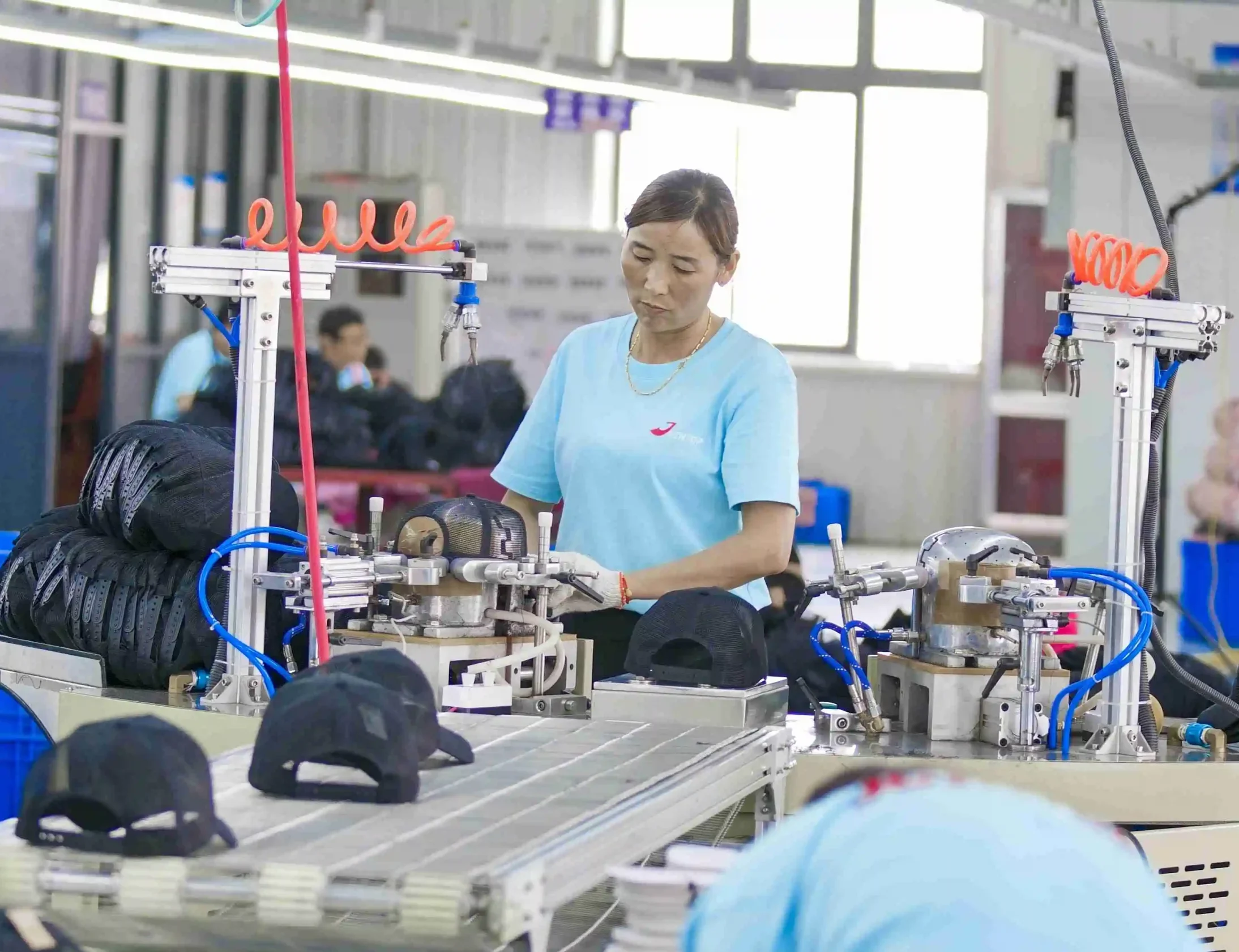 Performance caps being pressed on crown forms during production