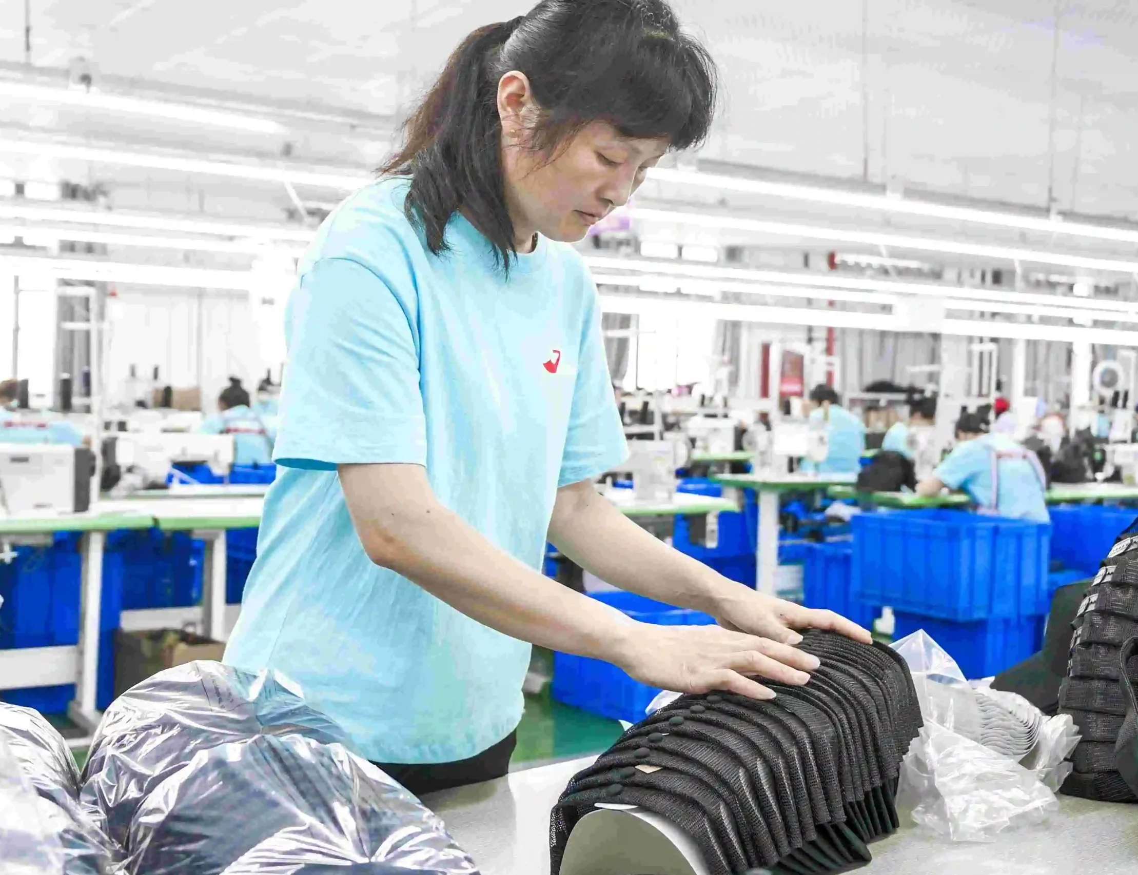 Factory worker arranging caps during the packing stage