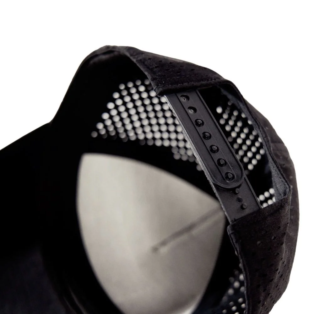 Inside view of a perforated black performance cap with an adjustable snap closure