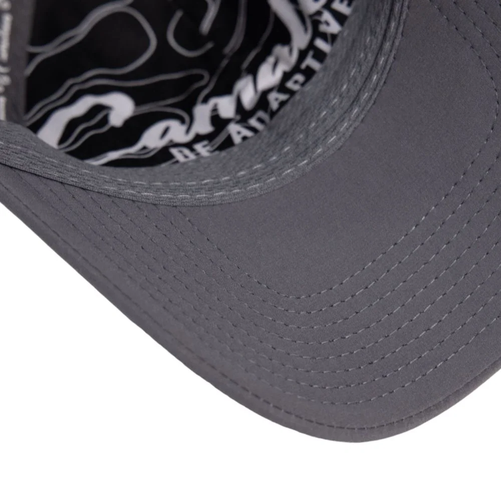 Close-up of a grey cap visor showing parallel topstitch rows