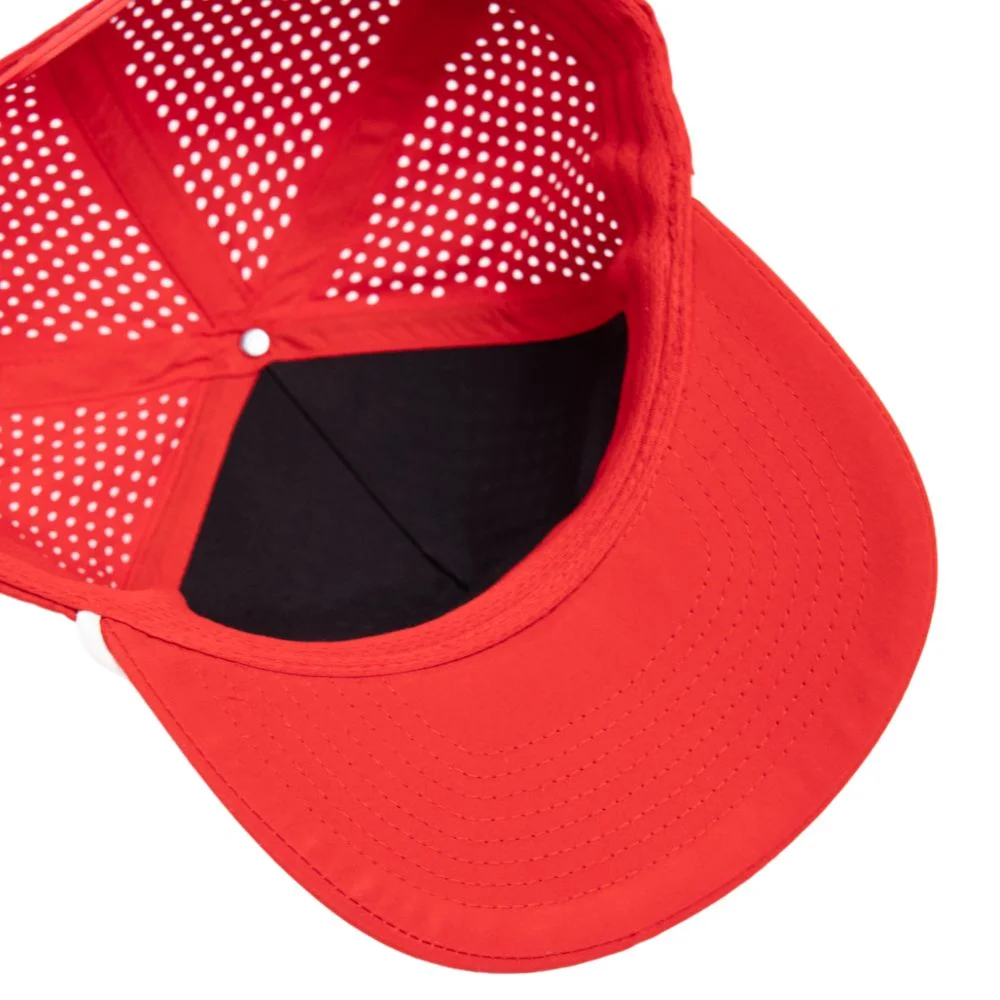 Inside view of a red performance cap showing perforated panels, taped seams, and visor stitching
