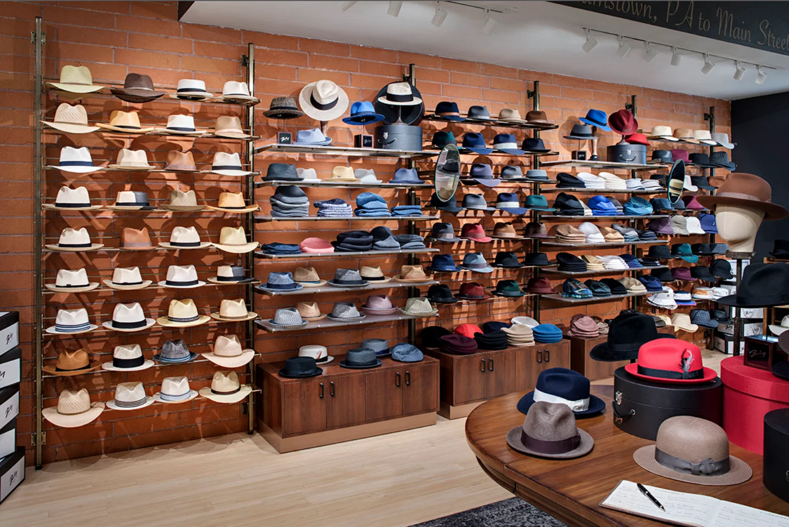 Store display with various hats on wooden shelves Store display with various hats on wooden shelves