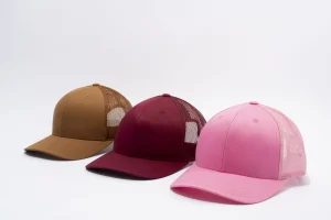 Three trucker hats in brown burgundy and pink with mesh backs Three trucker hats in brown burgundy and pink with mesh backs