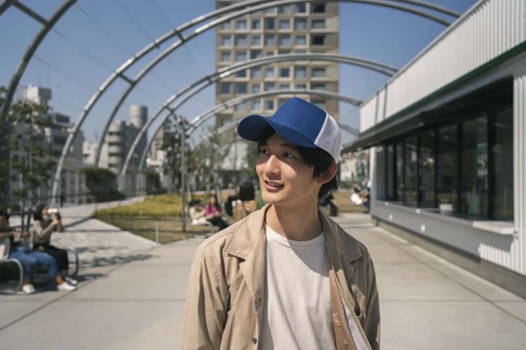 smiley man posing with trucker hat medium shot