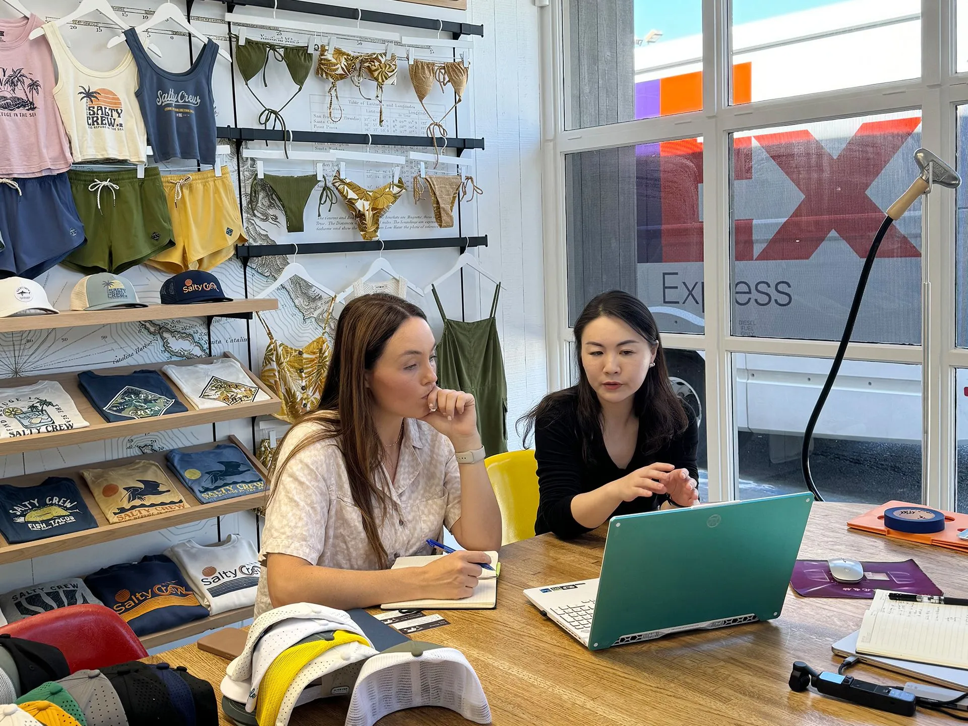 Jointop partner in a meeting with caps and apparel samples Jointop partner in a meeting with caps and apparel samples