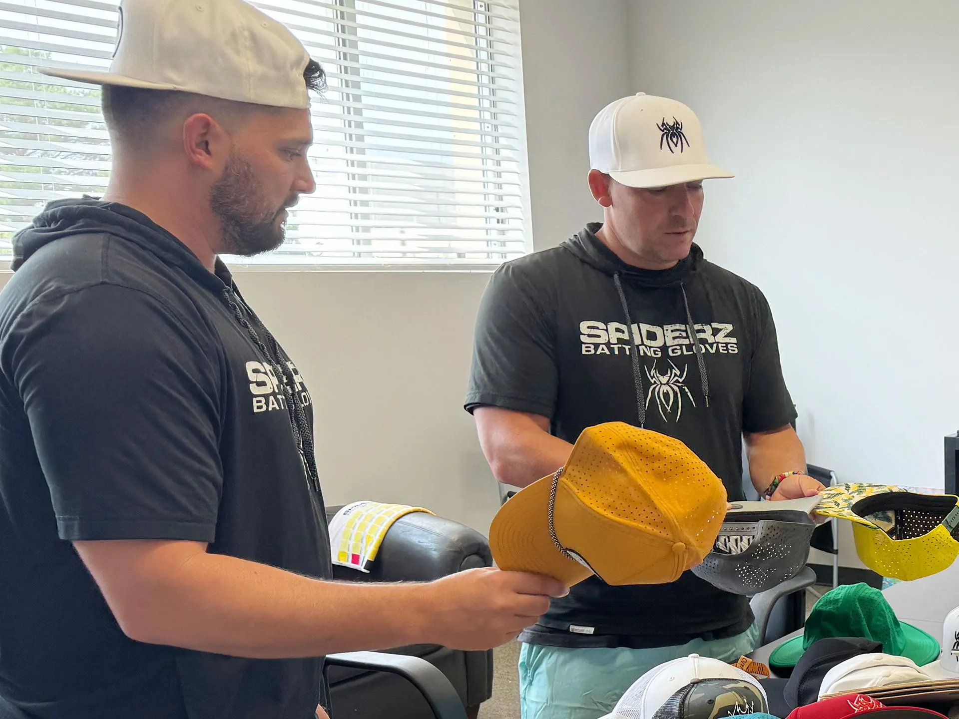 Two people comparing perforated cap samples