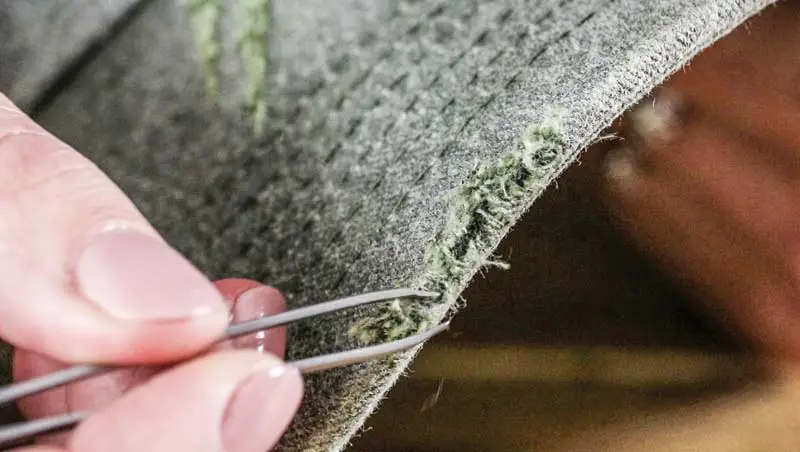 Tweezing Cap Fabric Close up of tweezers fraying cap fabric