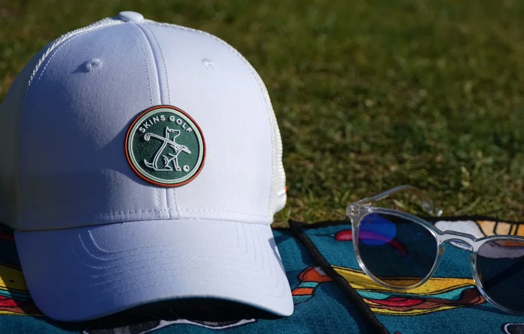 White Golf Cap White cap with Skins Golf logo on grass