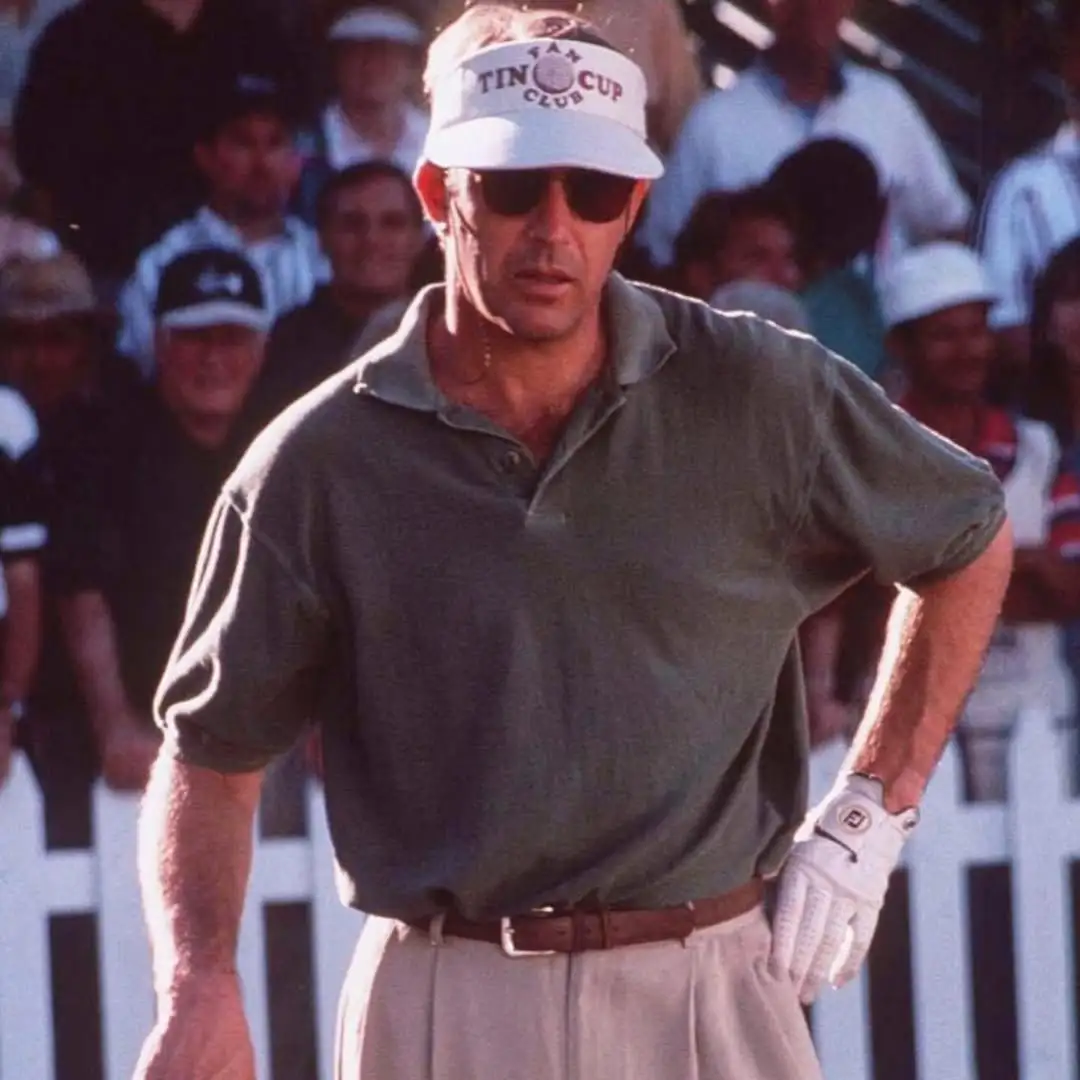 Woman in Golf Visor Woman swinging golf club in white visor