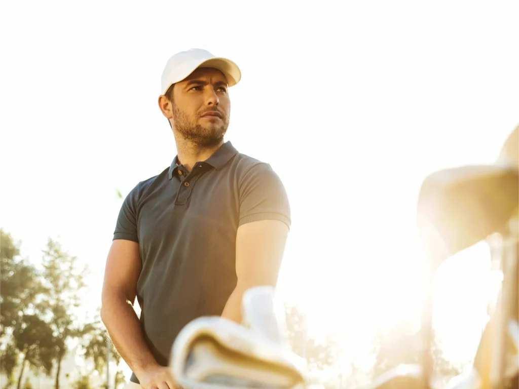 A man is playing the golf with golf hat