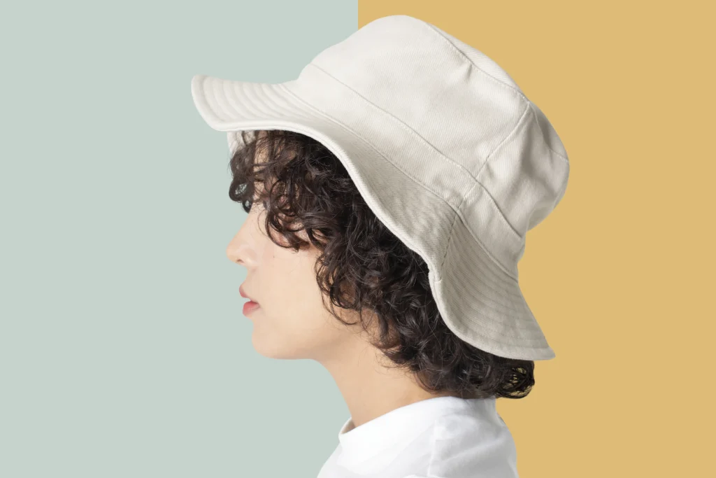 beautiful woman white bucket hat fashion studio shoot