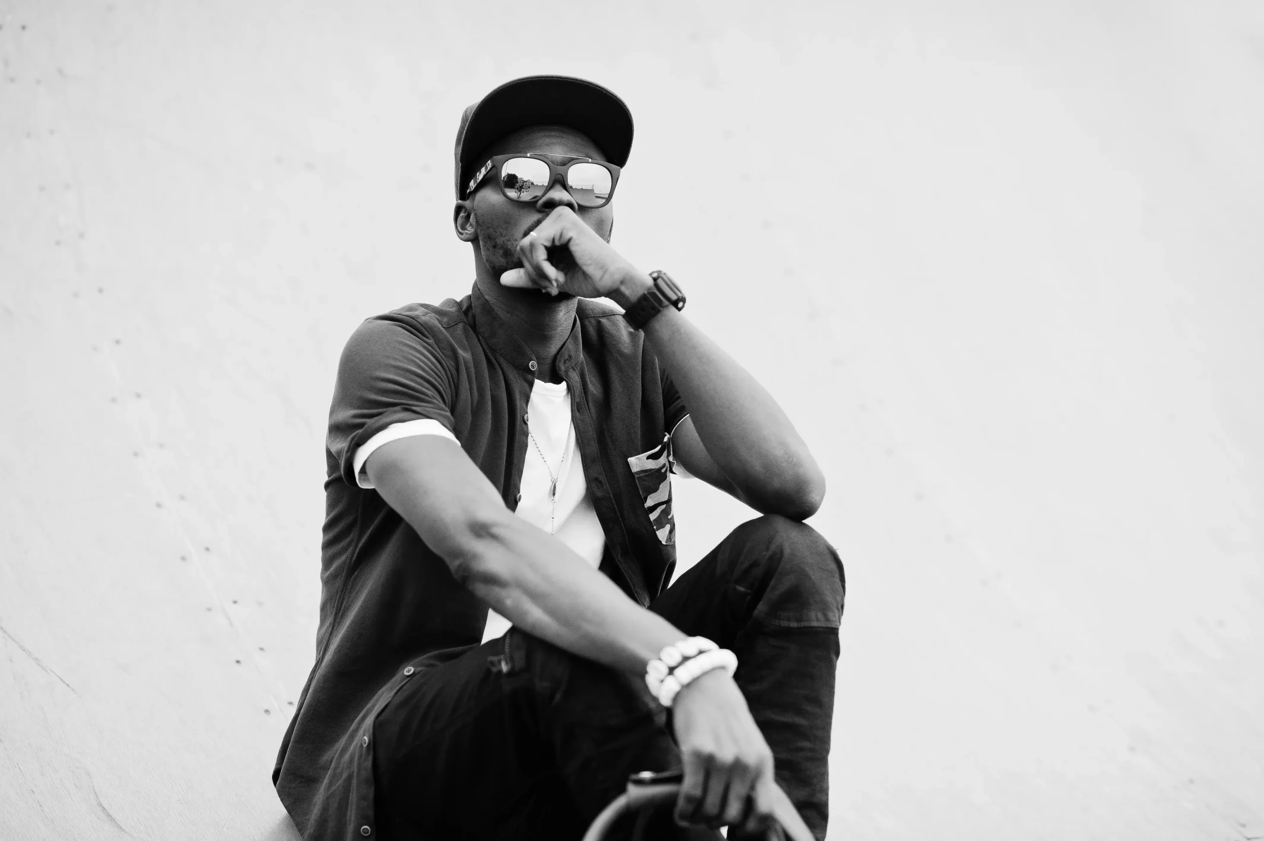 portrait sitting stylish african american man wear sunglasses cap with handbag outdoor street fashio compressed portrait sitting stylish african american man wear sunglasses cap with handbag outdoor street fashio compressed