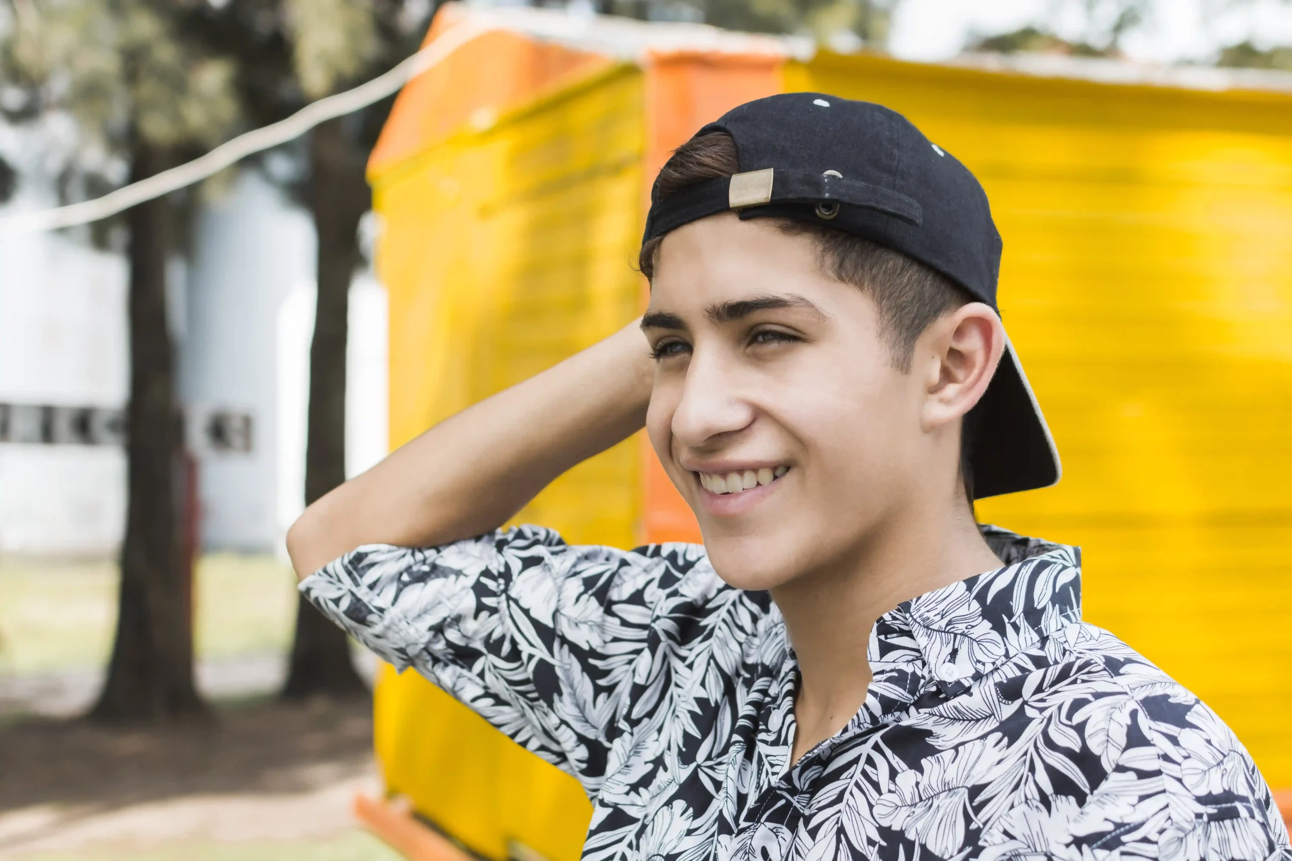stylish smiling teenage boy s hand his head stylish smiling teenage boy s hand his head