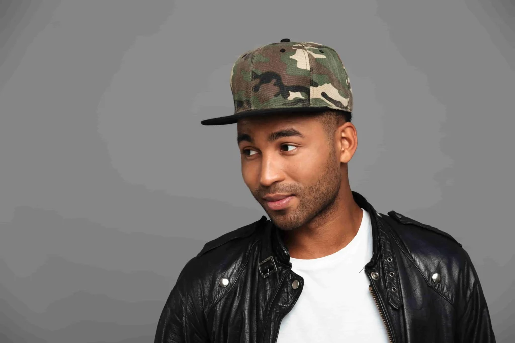 handsome afro american man camouflage cap looking aside