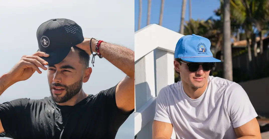 Two men wearing black and blue snapback hats