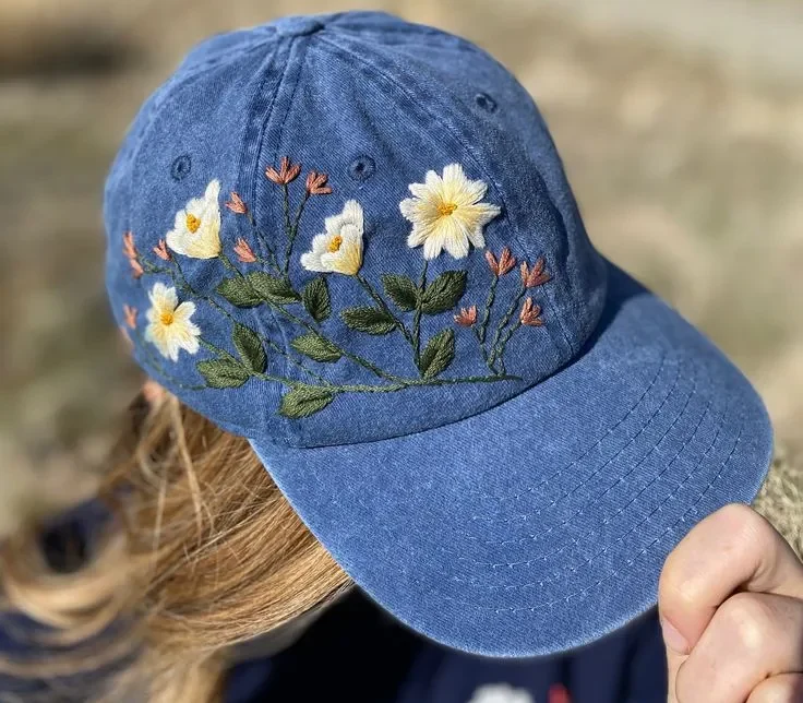 Blue embroidered cap with yellow and white flowers Blue embroidered cap with yellow and white flowers