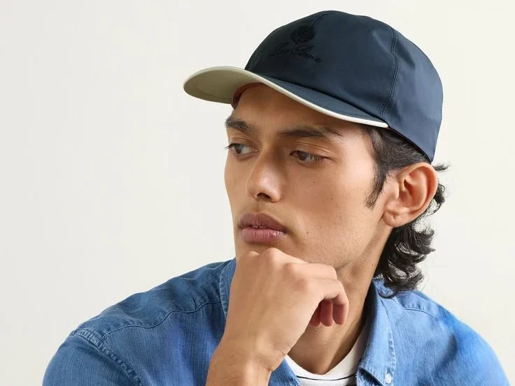 Man wearing navy baseball cap with denim shirt Man wearing navy baseball cap with denim shirt