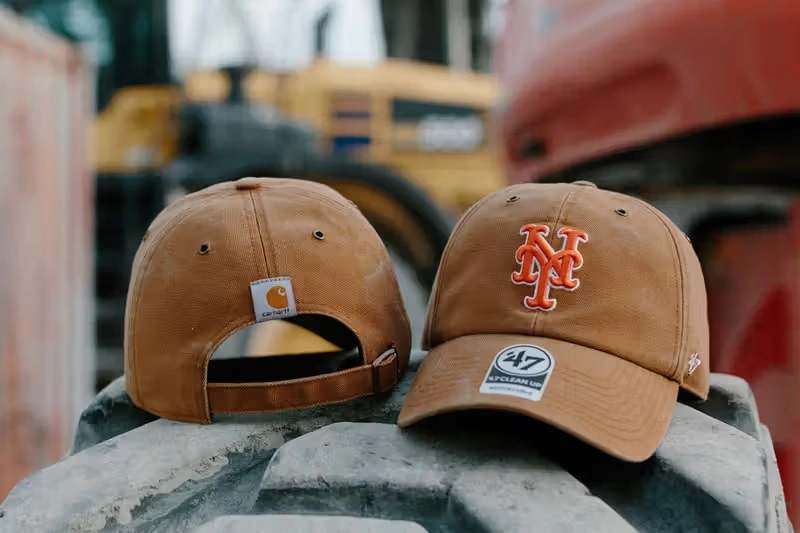 Brown Carhartt x 47 Mets caps on construction equipment