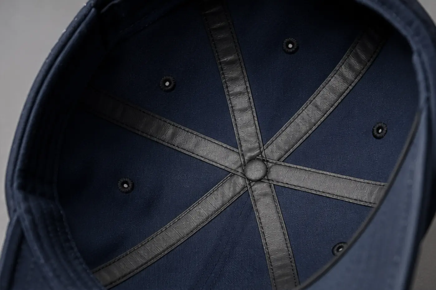 Inside view of seam-sealing tape bonded over the crown seams of a waterproof golf cap